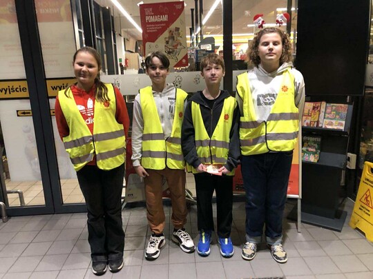 Wolontariusze w kamizelkach odblaskowych.